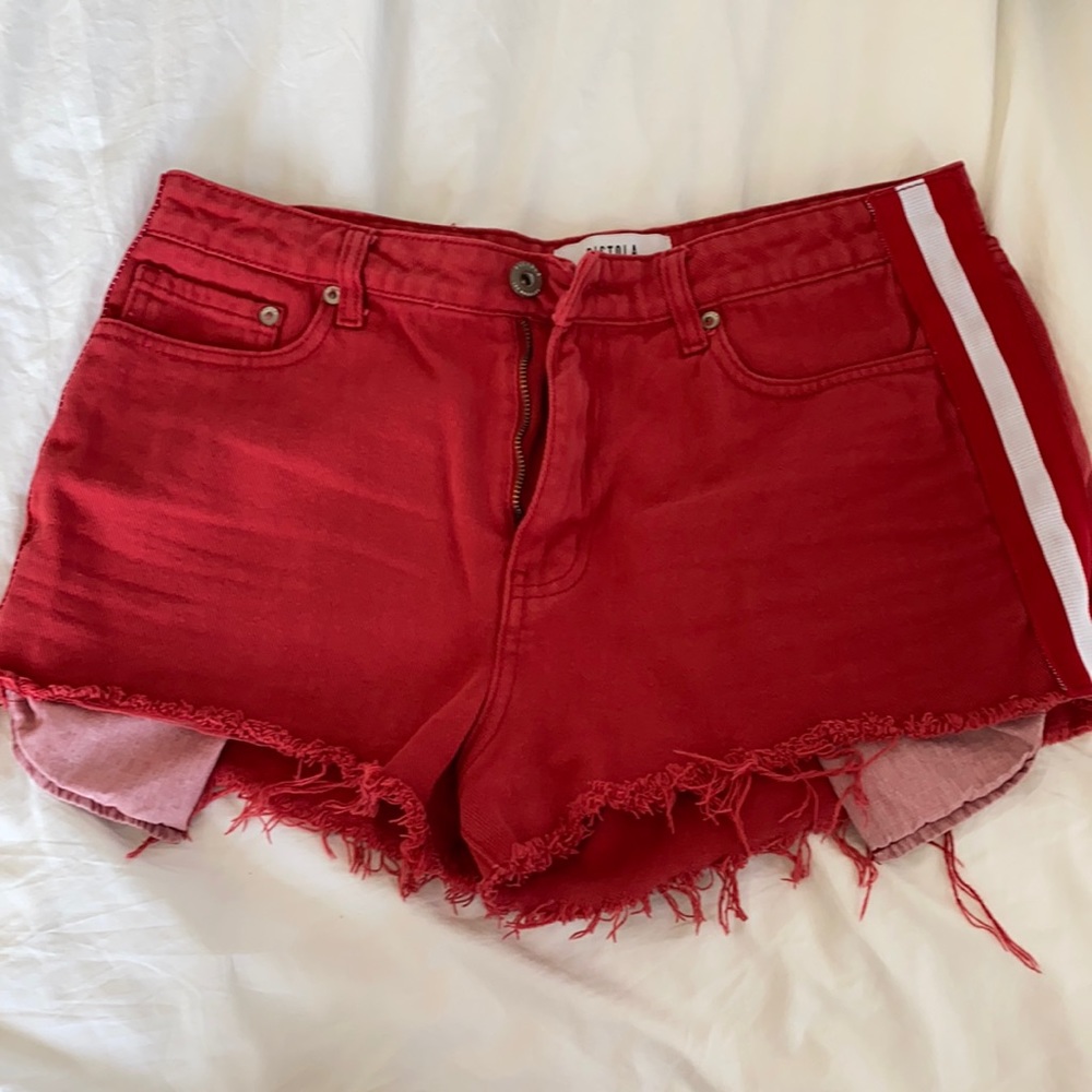 Red shorts with white and red stripes on the side.